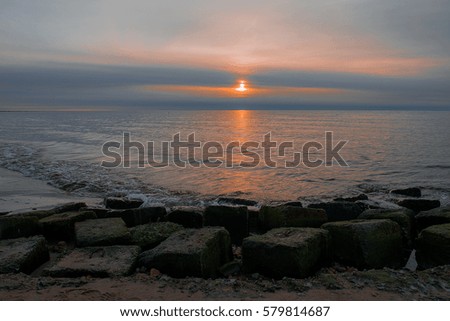 fantastically beautiful sunset at the Baltic Sea, the golden reflection of the sun on the waves and romantic mood, multicolored background for your project, a perfect work of art
