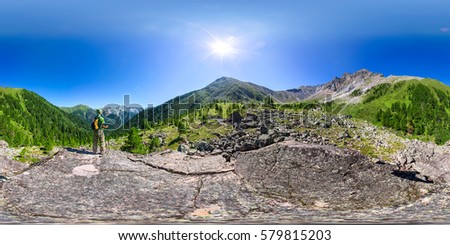 Spherical panorama 360 degrees 180 man with backpack standing in mountains. vr content Royalty-Free Stock Photo #579815203