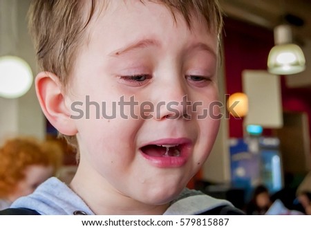 Cute Caucasian 4 year old child crying. Upset bullied little kid stock image.