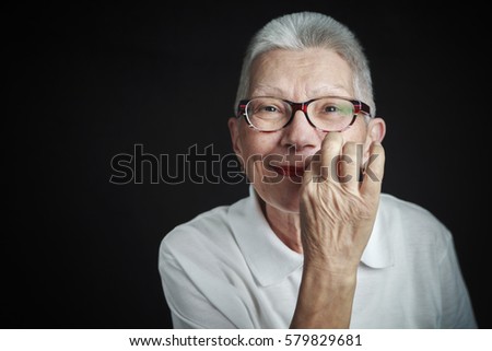 Senior old woman zipping her mouth, asking you to be quiet, happy and cheerful