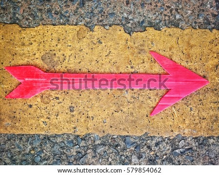 Red arrow sign on the road background