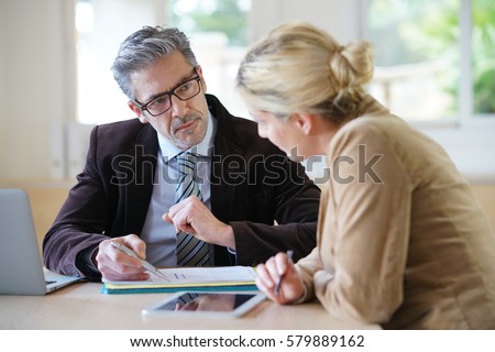 Woman meeting notary for advice Royalty-Free Stock Photo #579889162