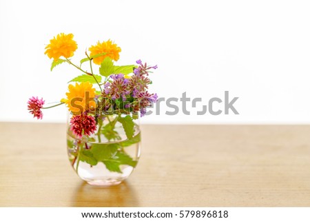 spring flowers in a glass vase on a table