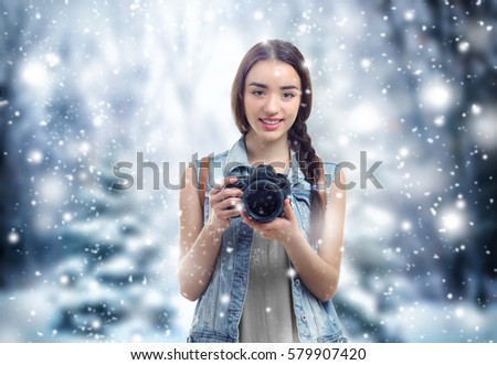 Professional photographer on winter landscape background