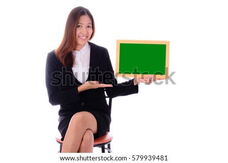 Smiling businesswoman sitting and holding green banner on white background.
