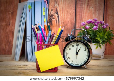 pencil beam in the paste sticky note and alarm clock