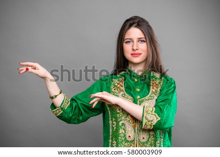 Close up portrait of beautiful eastern woman in green sari