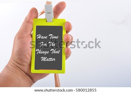 Hand holding name tag with text "Have Time For The Things That Matter"