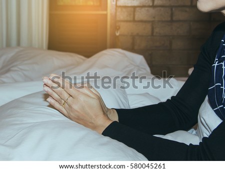 woman hands  praying on pillow in bedroom
