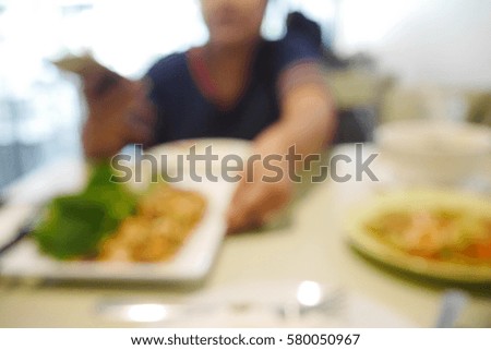 Picture blurred  for background abstract and can be illustration to article of woman eating food in restaurant