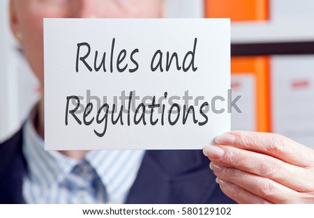 Rules and Regulations - Businesswoman with sign and text in the office
