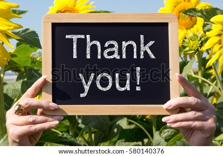 Thank you - chalkboard with hands and flowers in the summer garden