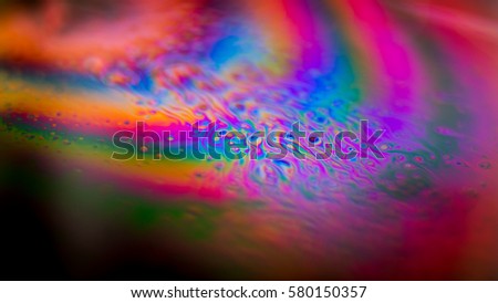 Nice colored abstract background, you see a closeup of movements in soap bubbles. 