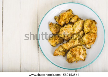 Pieces of fried chicken in breadcrumbs on plate. Studio Photo