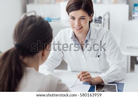Female doctor giving a consultation to a patient and explaining medical informations and diagnosis Royalty-Free Stock Photo #580163959