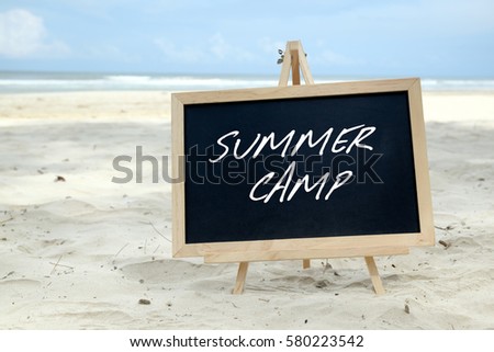 SUMMER CAMP. Chalkboard with written message and beautiful beach background.