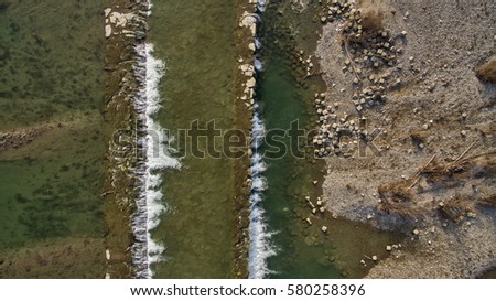 aerial view of river waterfalls in italian countryside