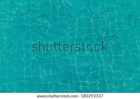 Flagstone pool under clear water for background texture