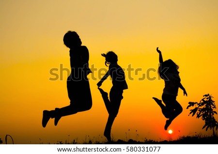 Happy family on dark background of sunsets (concept Silhouette)