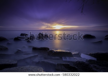 Eerie sunrise long exposure along the shoreline of Lake Michigan near Milwaukee.
