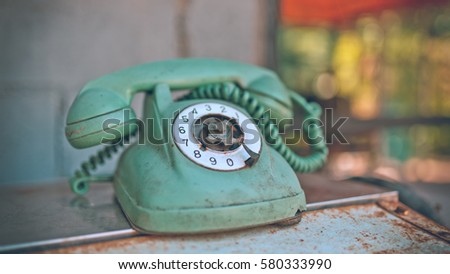 Old rusty grunge rotation phone in vintage style picture.