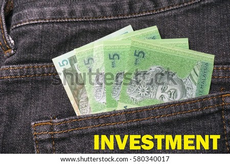 Malaysian Ringgit (MYR) bank note, currency of Malaysia – 5 ringgit Malaysia in the back pocket of black jeans.Finance, Banking and Saving concept.