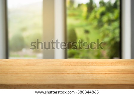 empty brown wooden table with blurred window in Coffee shop or restaurant background