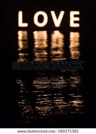 LOVE word with water reflection
