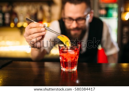 Bartender making alcohol coctail in restaurant Royalty-Free Stock Photo #580384417