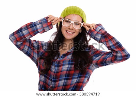Studio shot of happy beautiful woman smiling while wearing eyeglasses