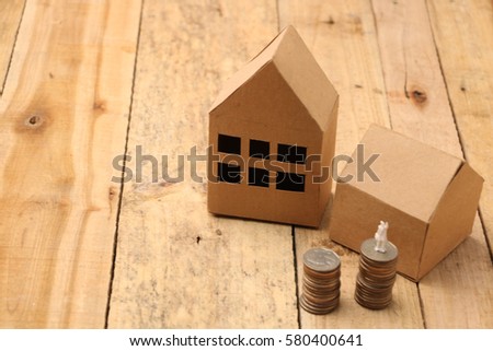 Mortgage loading and property document concept for real estate. businessman or agent on stacked coins reach the target, Concept of saving and success.