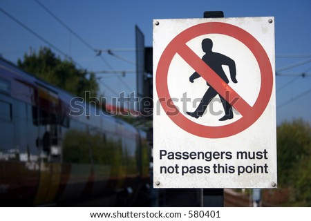 a railway danger sign with train in background