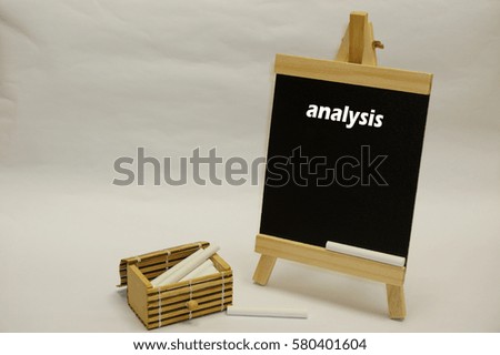 "Analysis" written on blackboard with chalks inside wooden box case isolated over white background