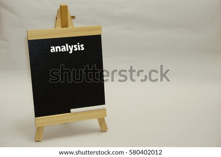 "Analysis" written on blackboard with chalk isolated over white background. Business concept.