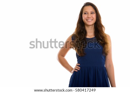 Studio shot of happy young beautiful woman smiling while posing and thinking