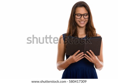 Happy young beautiful woman smiling and wearing eyeglasses while reading book