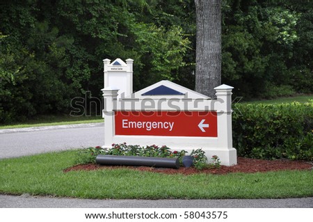 White wood sign with the words emergency on.