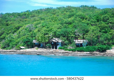 The beach houses with the green mountains background.