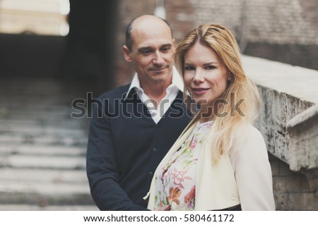  holidays, travel, tourism, people and dating concept - happy couple hugging over rome background
