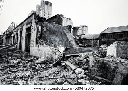 Old factory buildings destroyed. Ruins of industrial enterprise, dark debris destroyed factory premises in factory as result of economic crisis and earthquake.