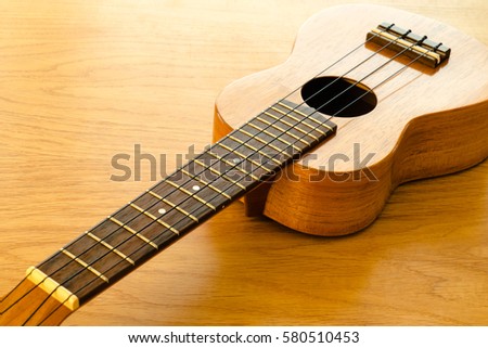 ukulele on a wooden table 