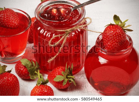jelly strawberry standing on the bank next to the table attributes and strawberries