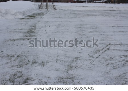 artificial turf football field cleared of snow