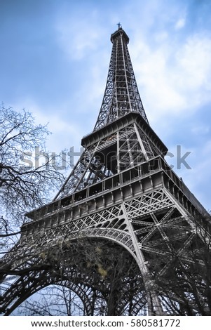 The Eiffel Tower against a cloudy blue sky in winter