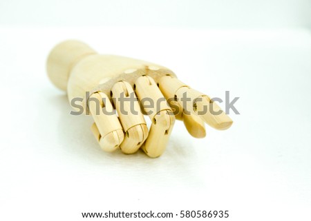hand of wood doll make fingers to pointing fingers white background 