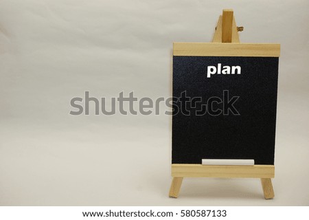 "Plan" word as a title written on blackboard isolated over white background