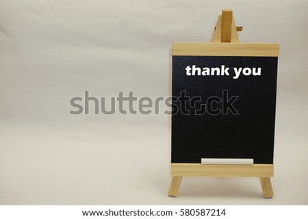 "Thank you" word written on blackboard isolated over white background