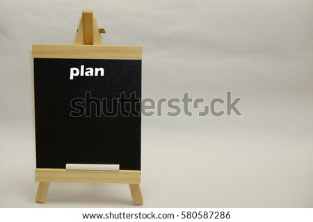 "Plan" word written on blackboard isolated over white background