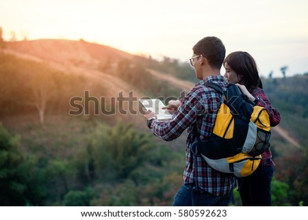 close up traveler man and girl looking location on tablet,man reading map