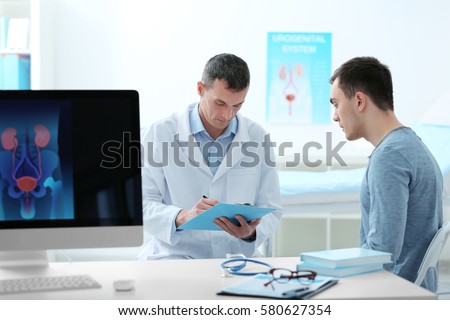 Man with urology problem visiting doctor at hospital Royalty-Free Stock Photo #580627354